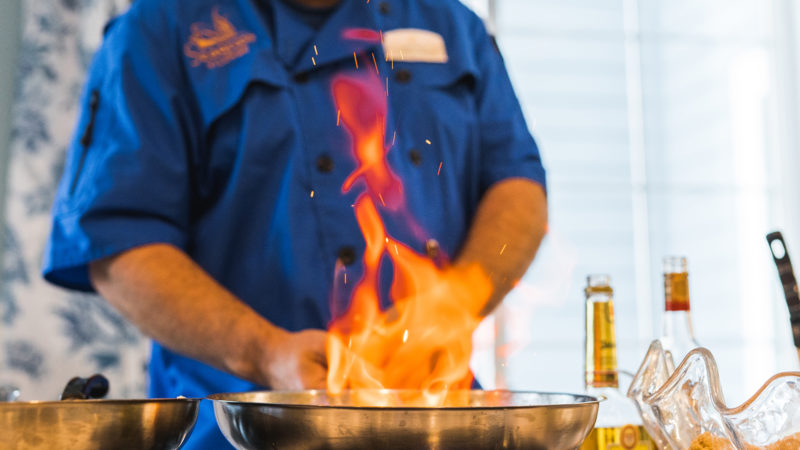 Chef shown flambeing dish during cooking demonstration